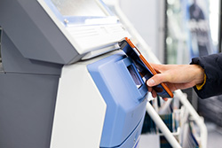 Person using cell phone at the ATM